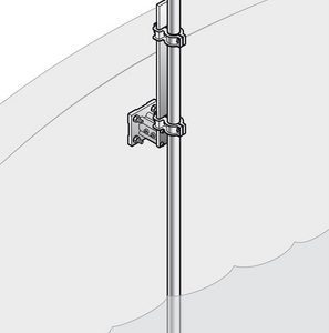 Vertical metal antenna mounted on a wall bracket beside a curved surface, with a coax cable trailing outward from the top.