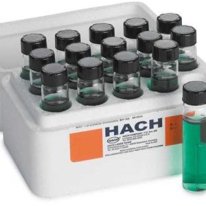 Tray of small glass vials with green liquid and black caps in a white foam rack, one vial standing outside the tray